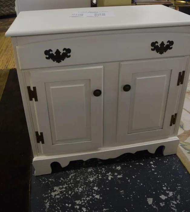 Painted white two-door cottage cabinet at Elite Repeat Furniture Consignment