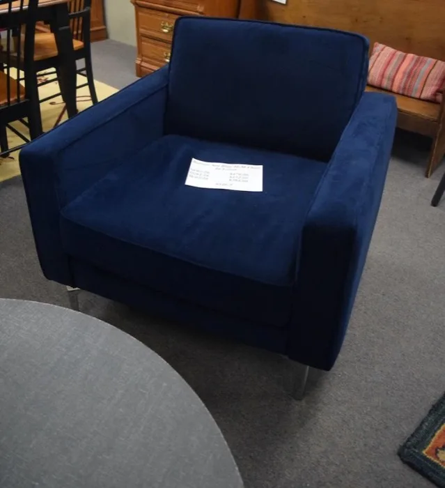 Matching sea-blue velvet chair at Elite Repeat Furniture Consignment